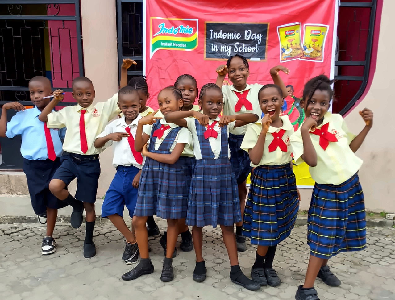 Primary pupils in Casterly Rock uniform celebrating Indomie Day at school